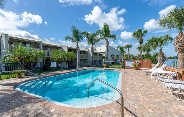 a view of a swimming pool with a lounge chairs
