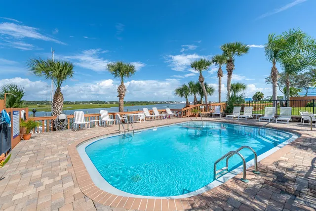 a view of a swimming pool with an outdoor seating