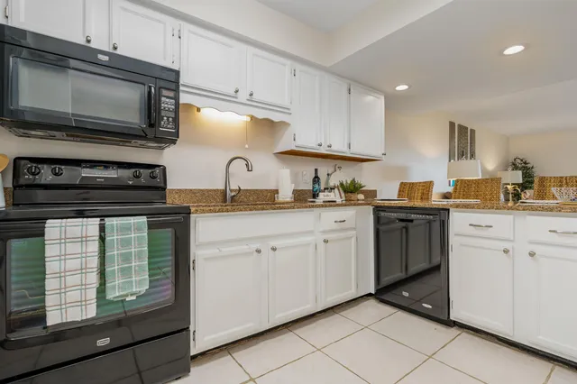 a kitchen with cabinets stainless steel appliances and sink