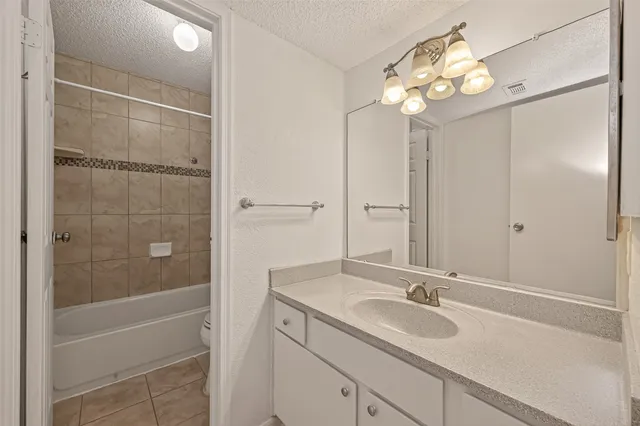 a bathroom with a toilet a sink and shower