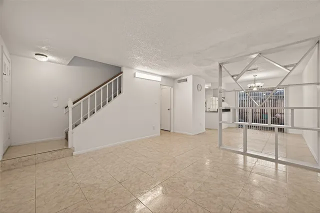 a view of an empty room with stairs