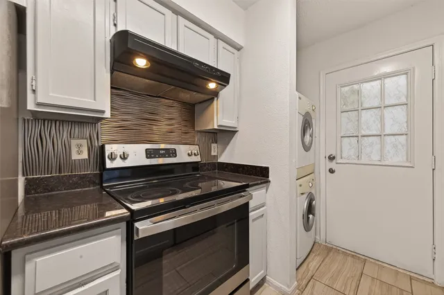 a stove top oven sitting inside of a kitchen