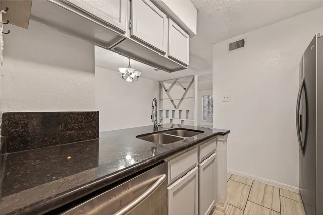 a kitchen with a sink and refrigerator
