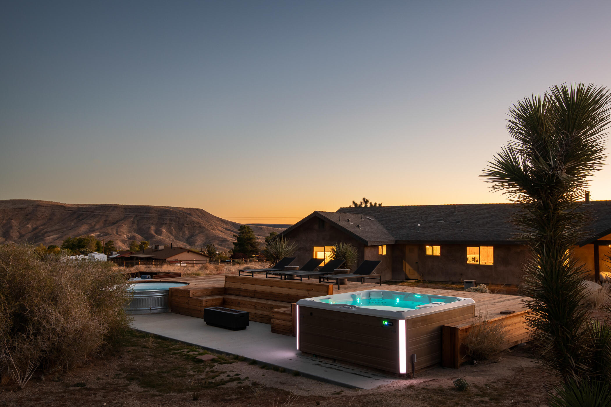 5544 Roy Rogers Road Pioneertown, CA 92268 - Photo 2 of 35 a view of a terrace with couches and a fire pit