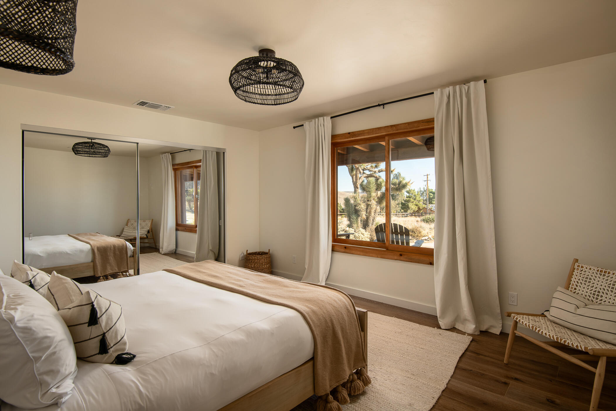 5544 Roy Rogers Road Pioneertown, CA 92268 - Photo 23 of 35 a bedroom with a bed and a large window with the outer view