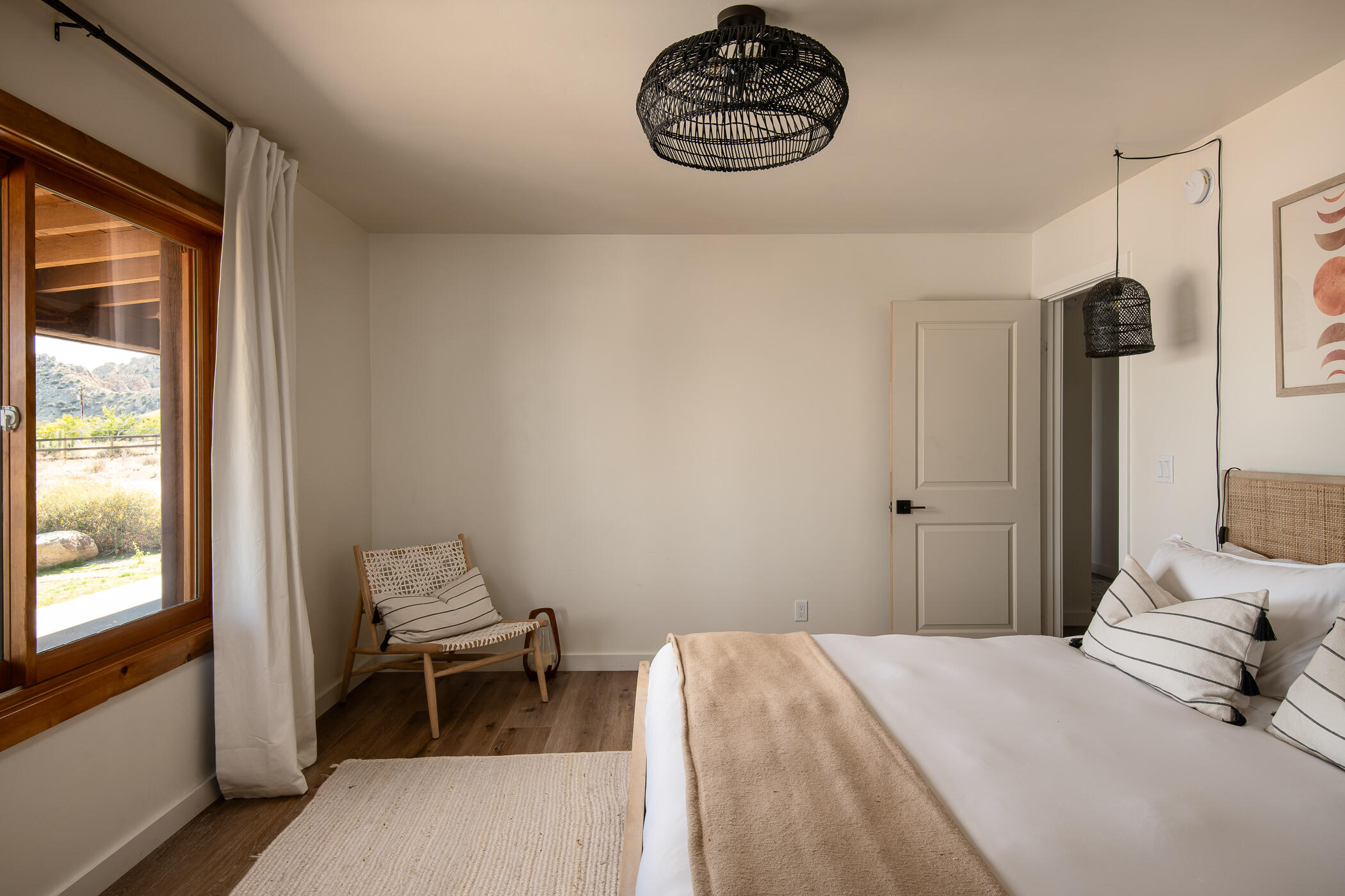 5544 Roy Rogers Road Pioneertown, CA 92268 - Photo 24 of 35 a bedroom with a bed and a window