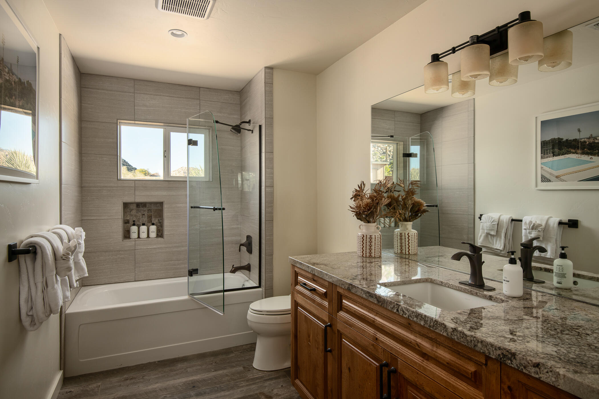 5544 Roy Rogers Road Pioneertown, CA 92268 - Photo 25 of 35 a bathroom with a granite countertop sink a toilet and bathtub