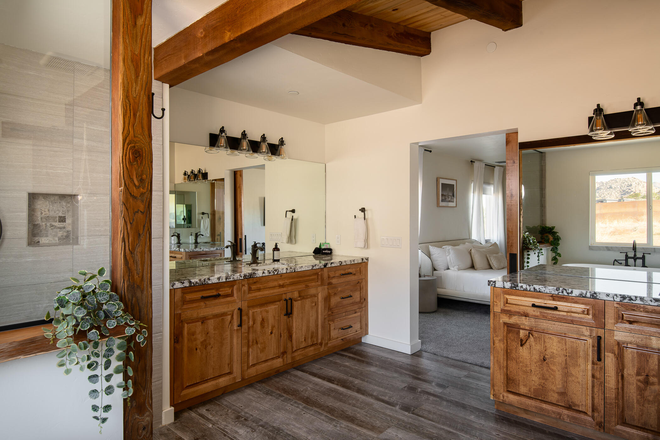 5544 Roy Rogers Road Pioneertown, CA 92268 - Photo 27 of 35 a spacious bathroom with a double vanity sink and a mirror