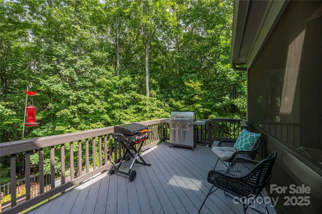 a view of balcony with chairs and wooden fence