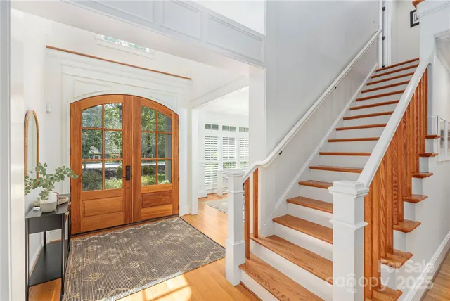 a view of staircase with wooden floor and a rug