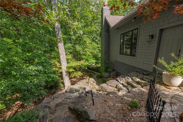 a front view of a house with a garden and yard
