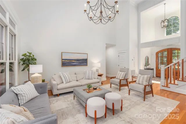 a living room with furniture and a chandelier