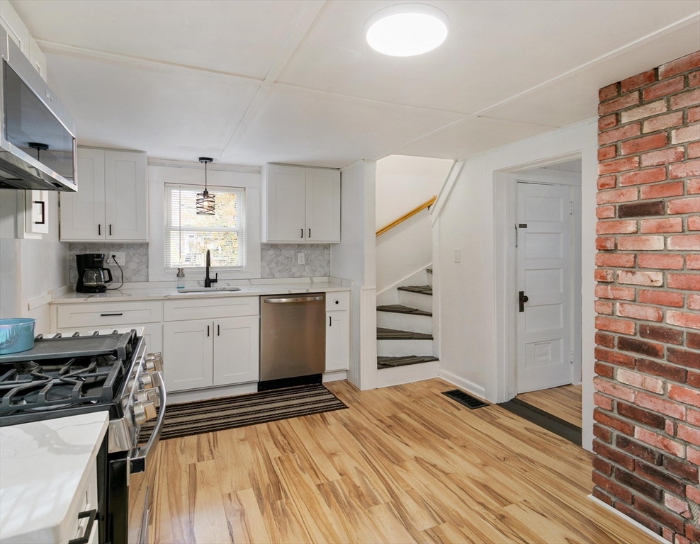 80 Brandy Brow Road Haverhill, MA 01830 - Photo 4 of 33 a kitchen with a refrigerator and a stove top oven
