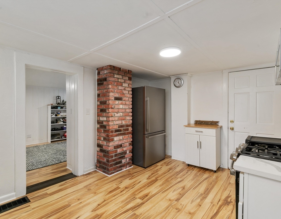 80 Brandy Brow Road Haverhill, MA 01830 - Photo 7 of 33 a view of a kitchen with wooden floor and electronic appliances