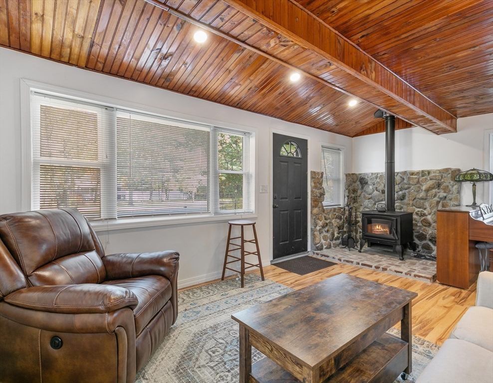 80 Brandy Brow Road Haverhill, MA 01830 - Photo 8 of 33 a living room with furniture a fireplace and wooden floor