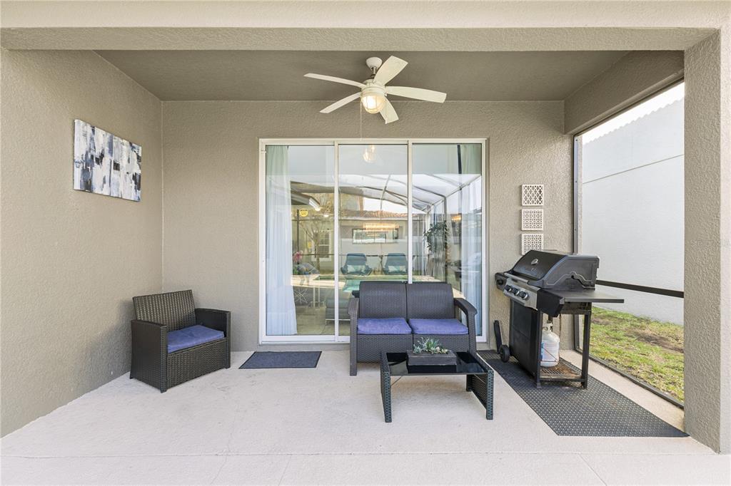 9006 Majesty Palm Road Kissimmee, FL 34747 - Photo 56 of 56 a bedroom with a bed and chair