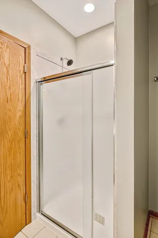 a bathroom with a glass shower door