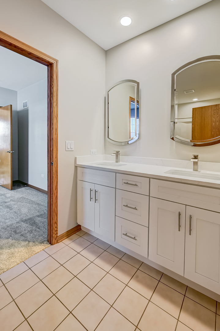 1938 Manning Road Darien, IL 60561 - Photo 17 of 23 a spacious bathroom with a double vanity sink mirror and