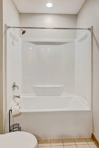 a bathroom with a shower and a toilet