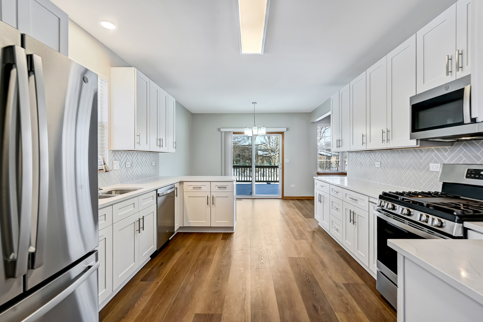 1938 Manning Road Darien, IL 60561 - Photo 7 of 23 a kitchen with stainless steel appliances a stove a sink and a refrigerator