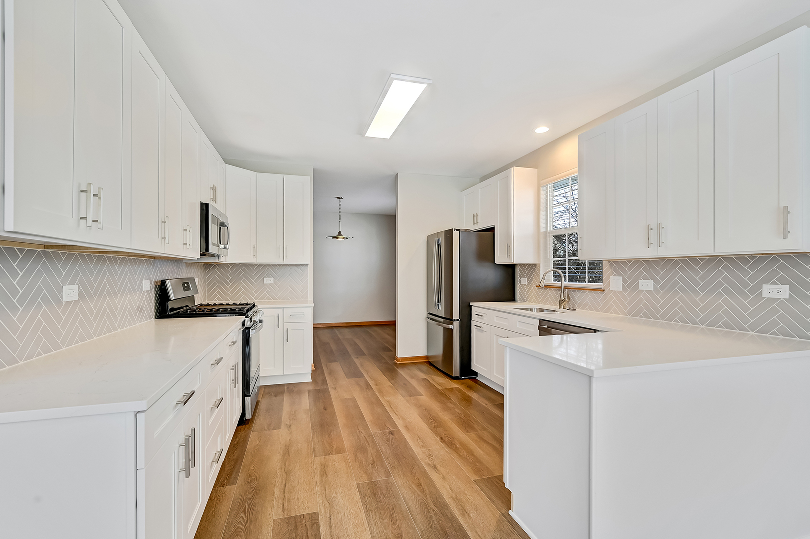 1938 Manning Road Darien, IL 60561 - Photo 8 of 23 a kitchen with stainless steel appliances a refrigerator sink and white cabinets