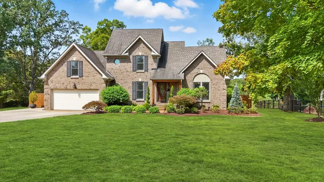 a front view of a house with a yard and garage