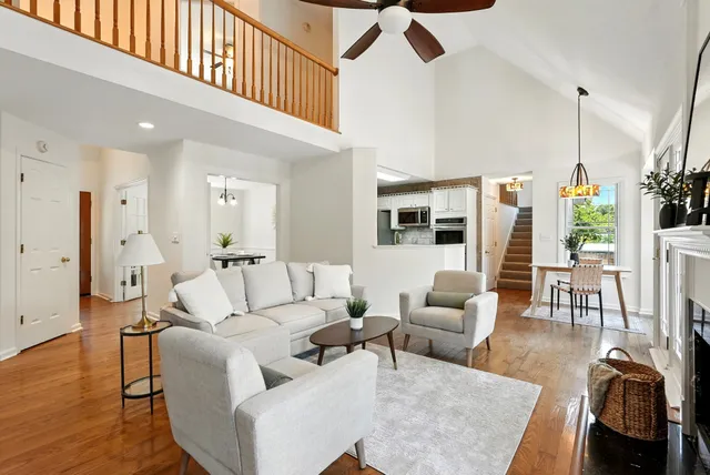 a living room with furniture a fireplace and a floor to ceiling window