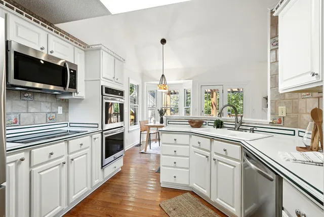 a kitchen with a stove a sink and a refrigerator