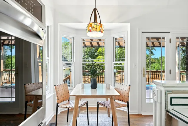 a view of a dining room with furniture window and wooden floor