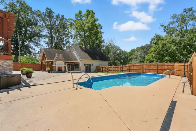 swimming pool view with a outdoor seating