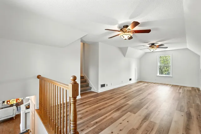 a bathroom with a granite countertop sink toilet and mirror