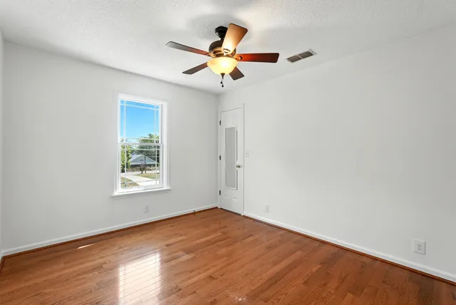 a view of a living room with furniture and a floor to ceiling window