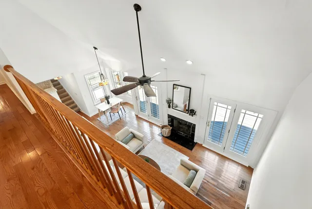 an empty room with ceiling fan and window