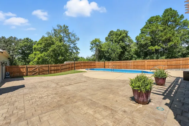 a view of a swimming pool with a patio