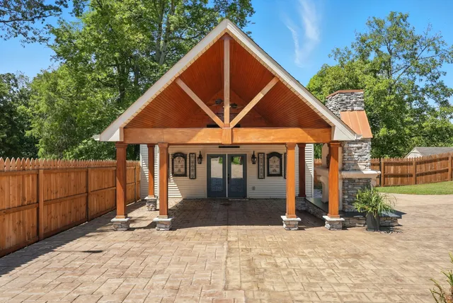 a backyard of a house with yard and outdoor seating