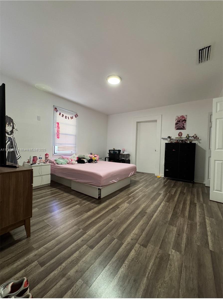 602 East 50th Street Hialeah, FL 33013 - Photo 11 of 20 a bedroom with a bed and a dresser