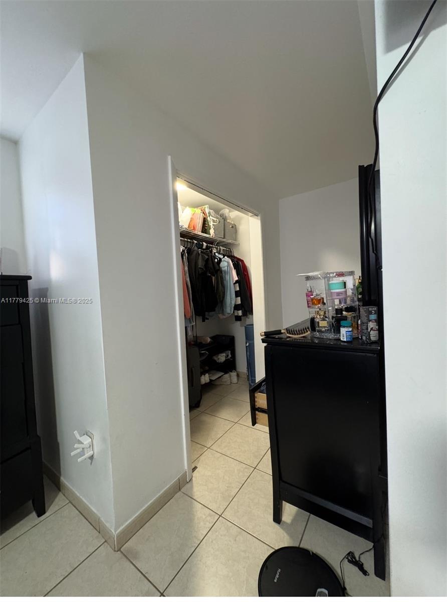 602 East 50th Street Hialeah, FL 33013 - Photo 13 of 20 a bed room with a bed and a mirror