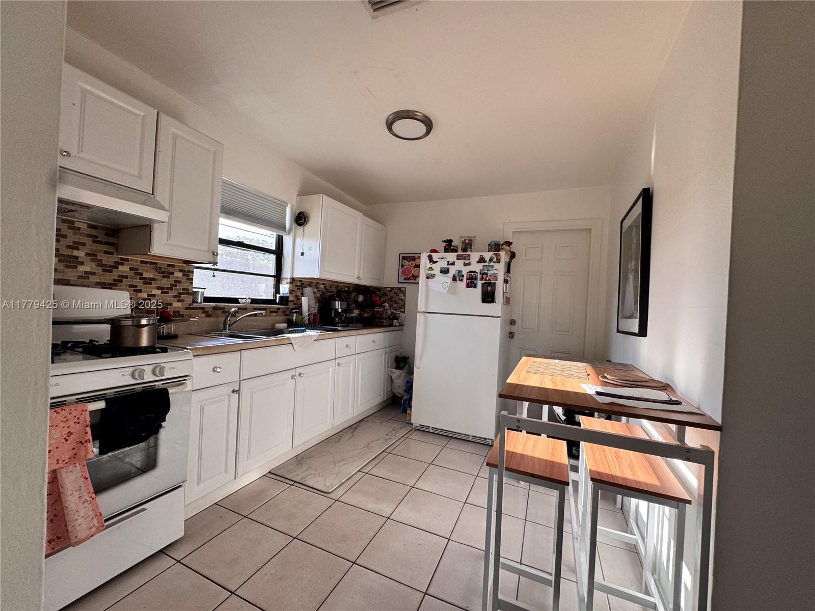 602 East 50th Street Hialeah, FL 33013 - Photo 17 of 20 a kitchen with stainless steel appliances a sink and cabinets