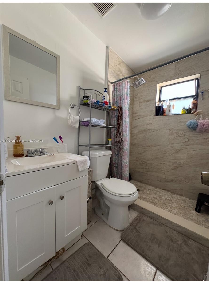 602 East 50th Street Hialeah, FL 33013 - Photo 18 of 20 a bathroom with a toilet sink and shower
