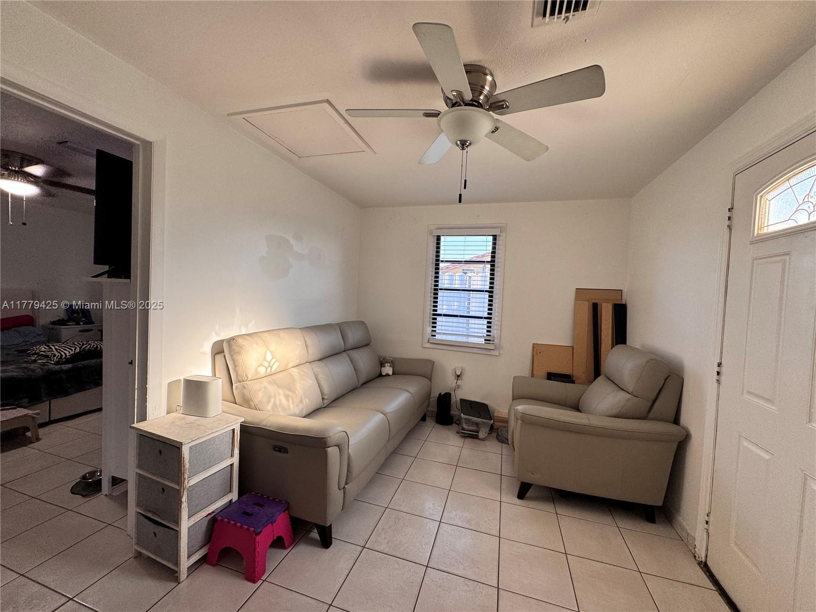602 East 50th Street Hialeah, FL 33013 - Photo 19 of 20 a living room with furniture and a window