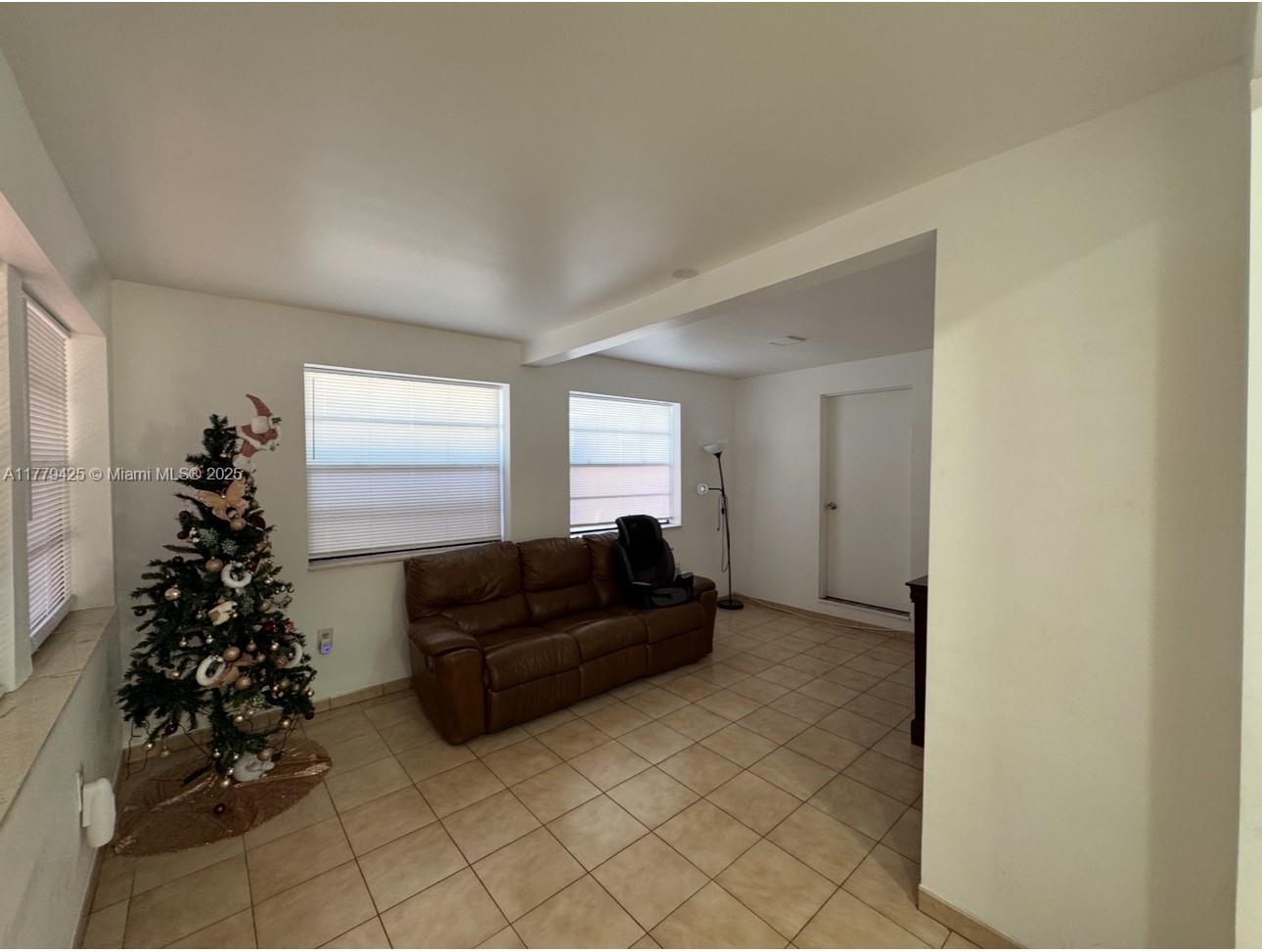 602 East 50th Street Hialeah, FL 33013 - Photo 3 of 20 a living room with furniture plant and a window