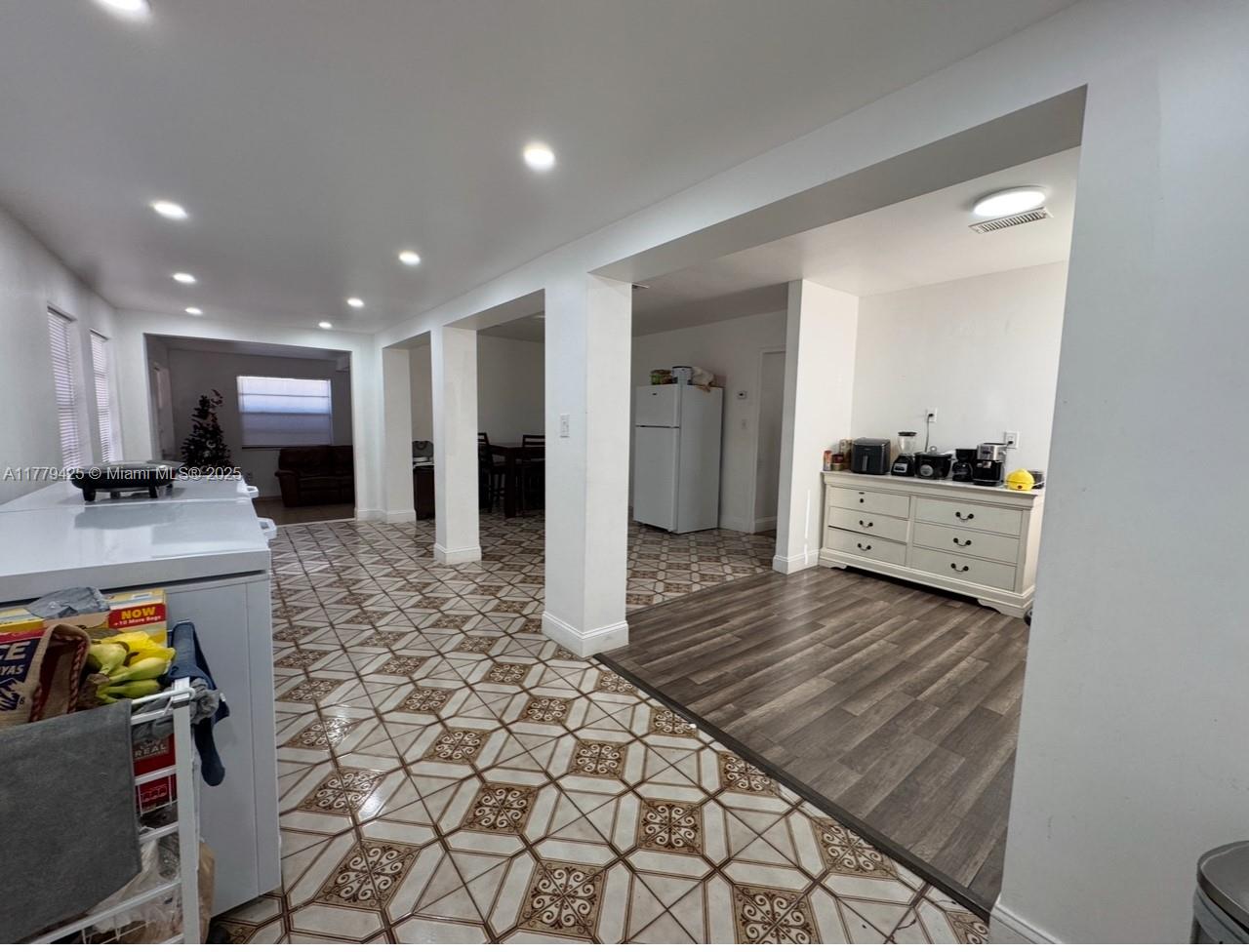 602 East 50th Street Hialeah, FL 33013 - Photo 5 of 20 a view of a hallway with wooden floor and furniture
