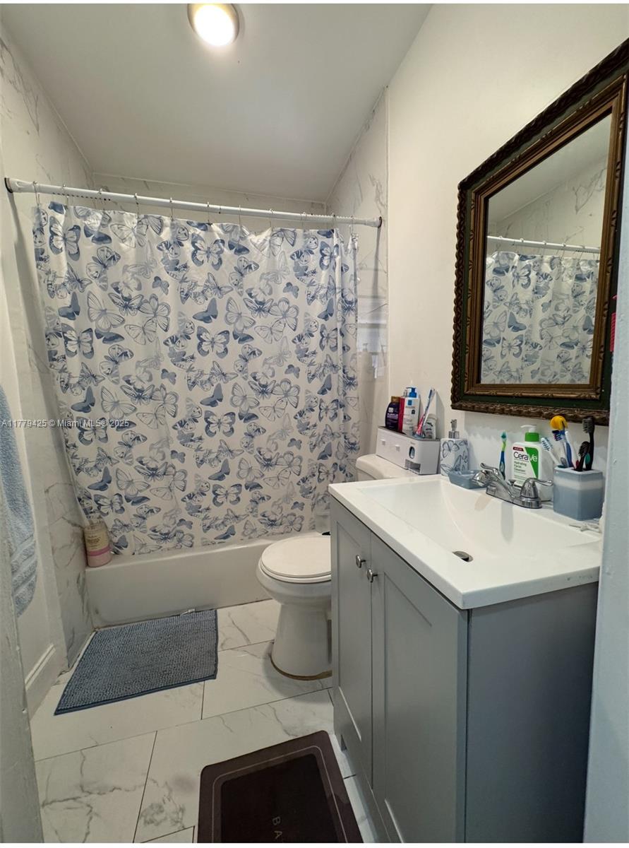 602 East 50th Street Hialeah, FL 33013 - Photo 6 of 20 a bathroom with a sink toilet and mirror