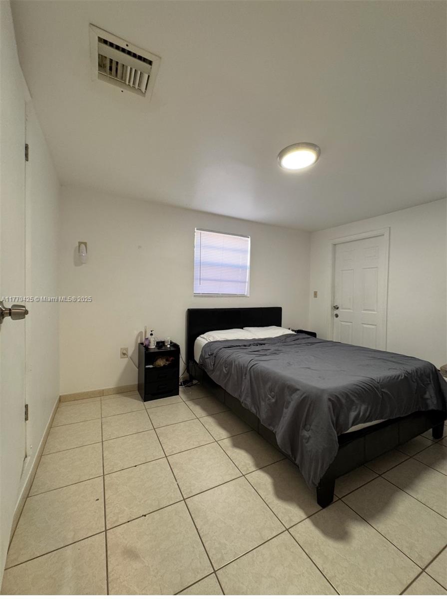 602 East 50th Street Hialeah, FL 33013 - Photo 7 of 20 a bedroom with a bed and a window