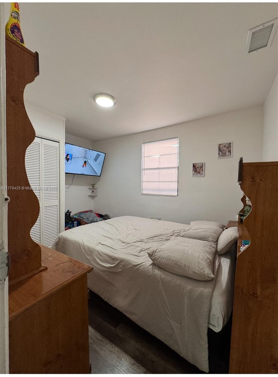 602 East 50th Street Hialeah, FL 33013 - Photo 9 of 20 a bedroom with a bed and a window