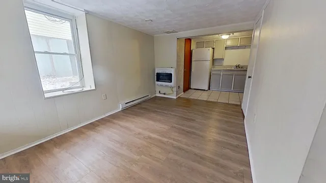 an empty room with windows and entryway