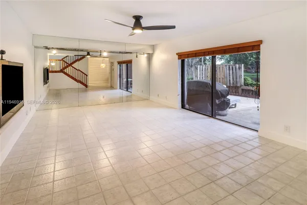 a view of a livingroom with wooden floor and stairs