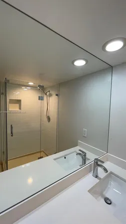 a bathroom with a sink toilet and a mirror