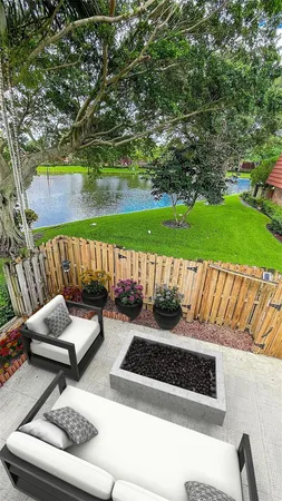 a view of a couches in patio of back yard