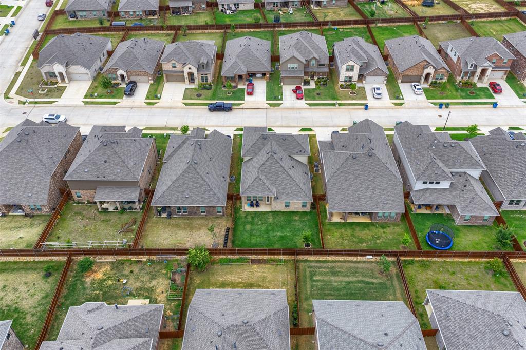 3808 High Country Road Aubrey, TX 76227 - Photo 28 of 36 Aerial view of a residential neighborhood featuring multiple single-family homes with pitched shingle roofs and fenced backyards